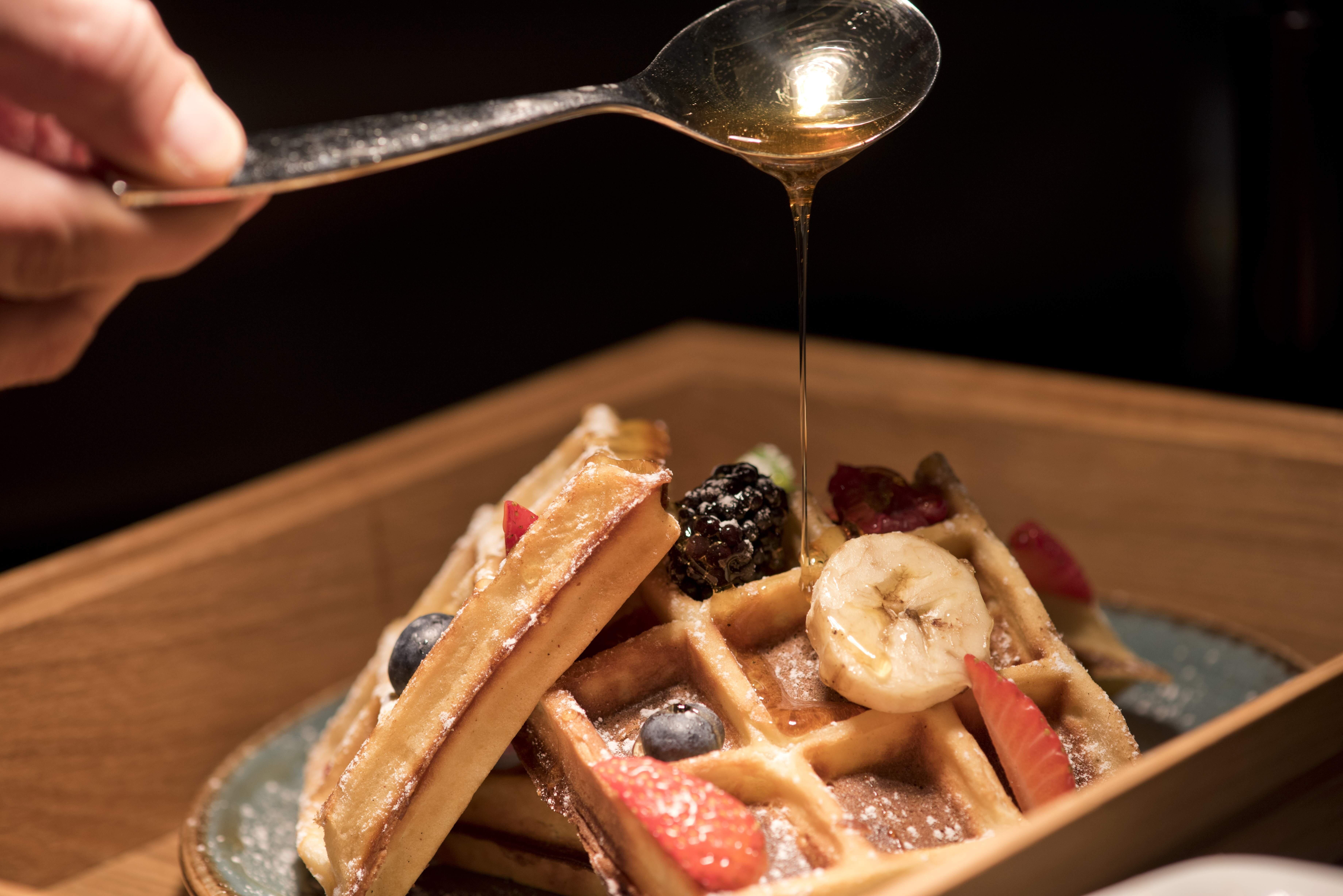 Voco Doha West Bay Suites By Ihg Экстерьер фото Maple syrup being drizzled on a plate of waffles